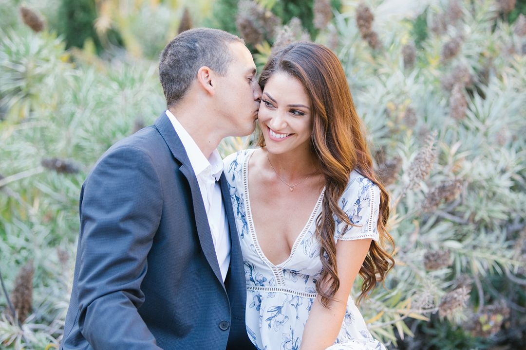 guy kisses girl on cheek during UCLA engagement session