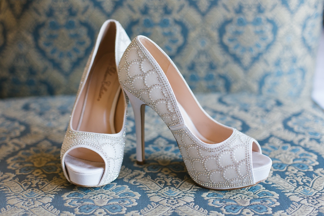 beaded high-heel bridal shoes on damask background