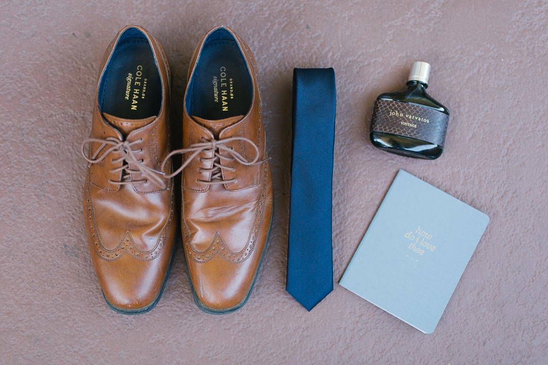 detail of groom's brown leather shoes and blue tie