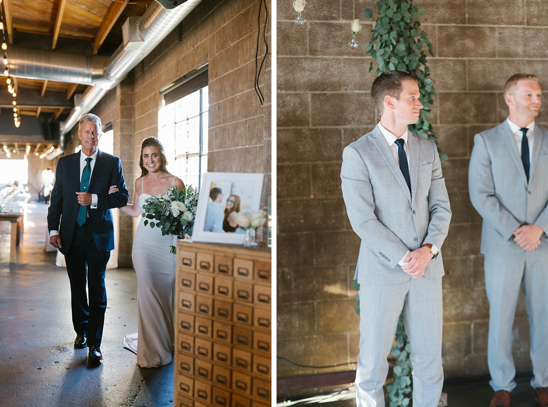 bride walks down aisle at smoky hollow studios while groom looks on