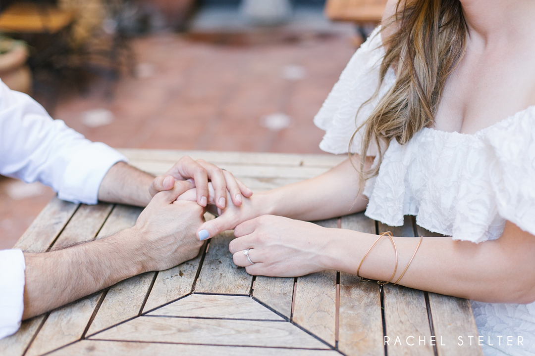 couple holds hands at engagement session in laguna beach