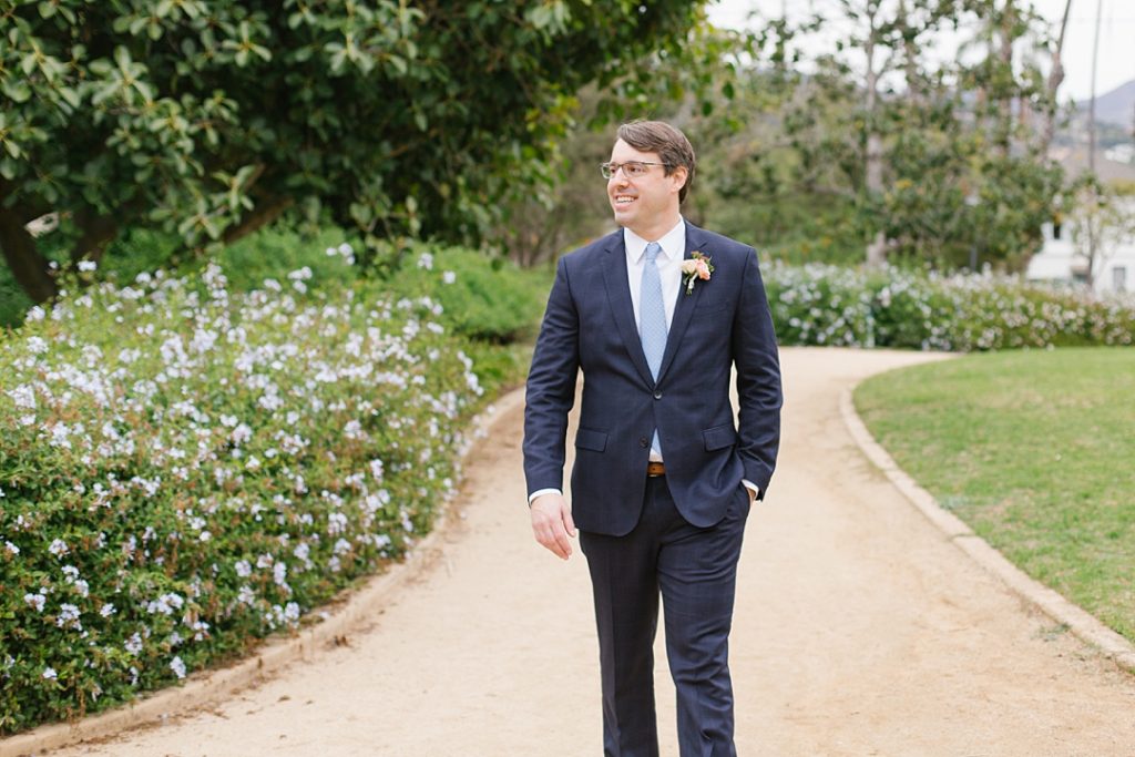 groom walks through alice keck memorial garden in santa barbara