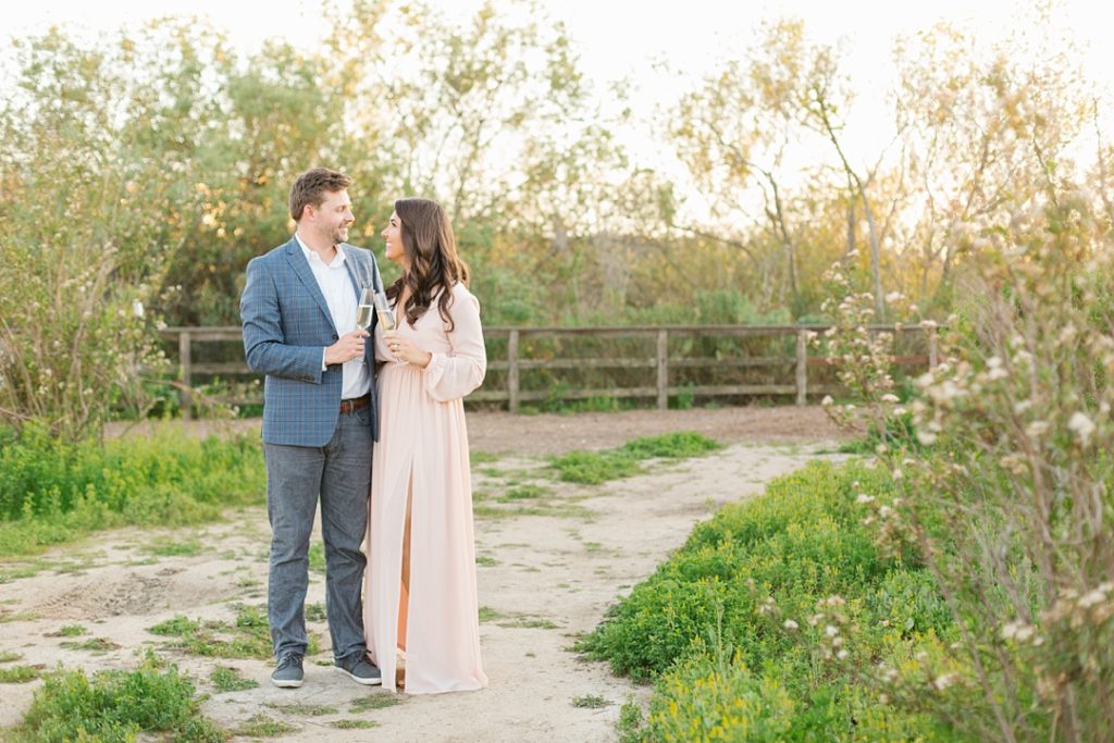 popping champagne during engagement session photos in playa vista