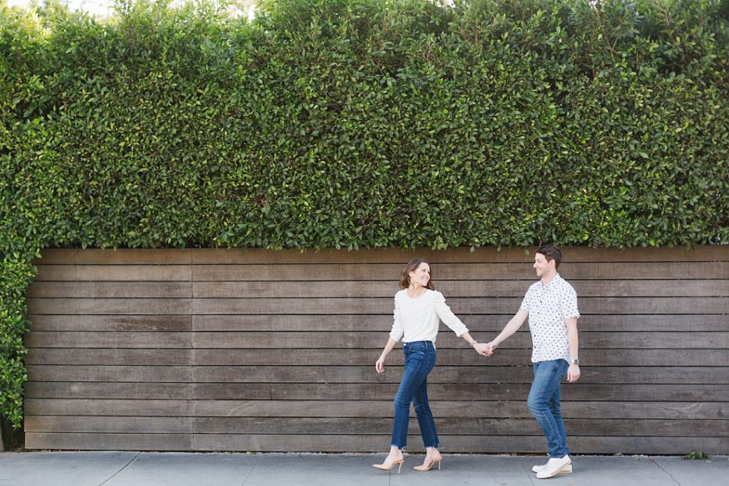 Couple walks down the street during WeHo engagement session