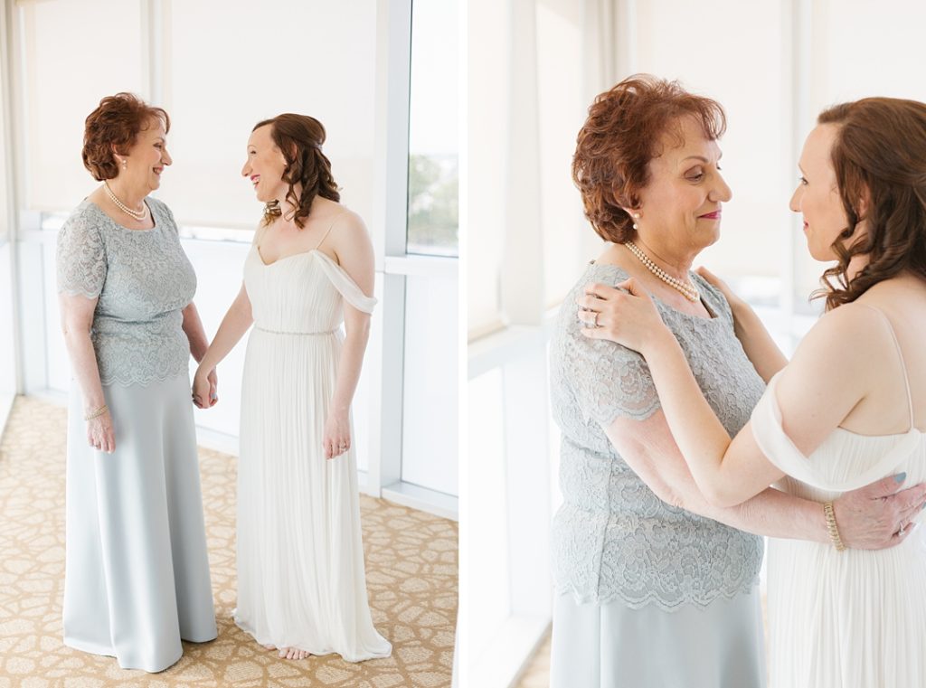 bride and her mother share a moment after she slips into her flowy BHLDN wedding gown