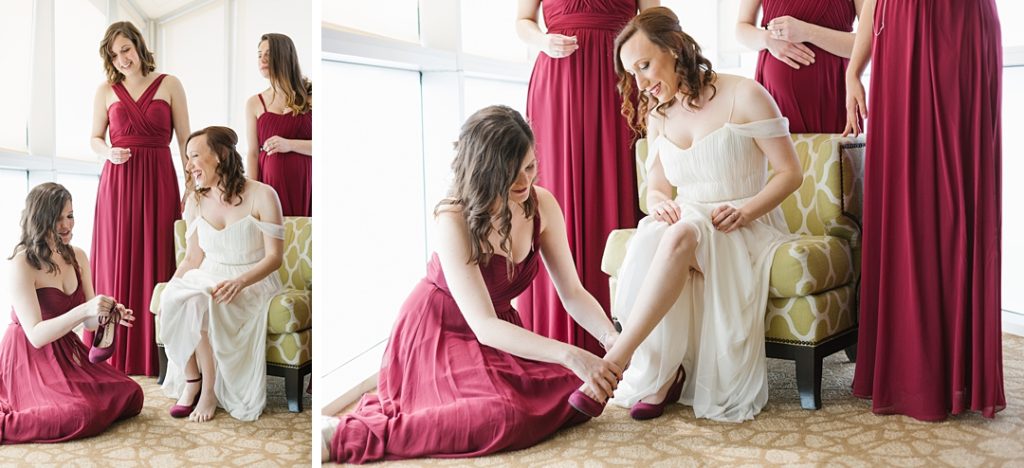 bride getting ready at Embassy Suites in Glendale, CA surrounded by bridesmaids in long maroon dresses
