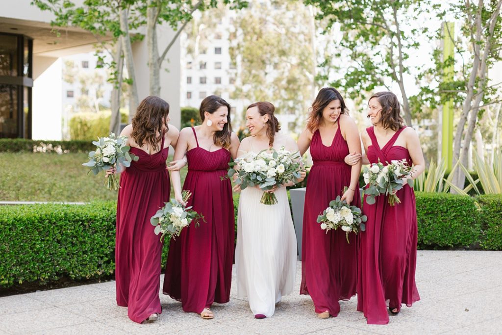 maroon bridesmaids dresses with white flowers for a spring wedding in Los Angeles, CA