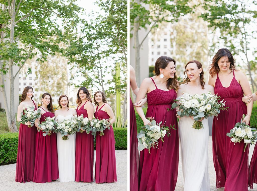 bridesmaids wearing maroon Birdy Grey dresses hold bouquets of white flowers and eucalyptus