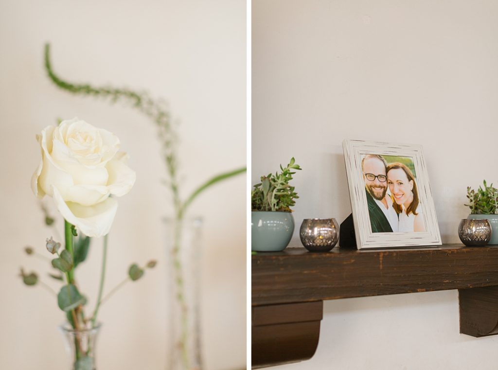 white rose in a bud vase and framed engagement photos make for clean and simple wedding decor