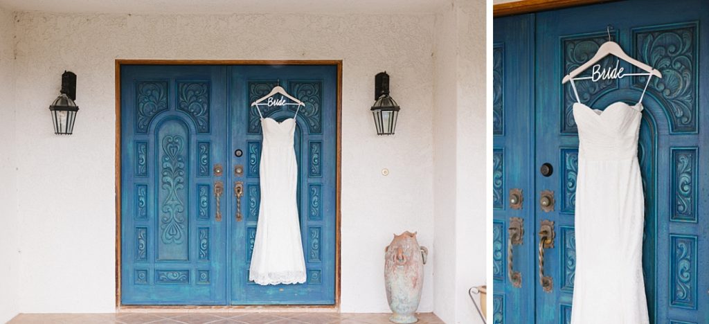 wedding dress hangs on blue door at temecula AirBnb