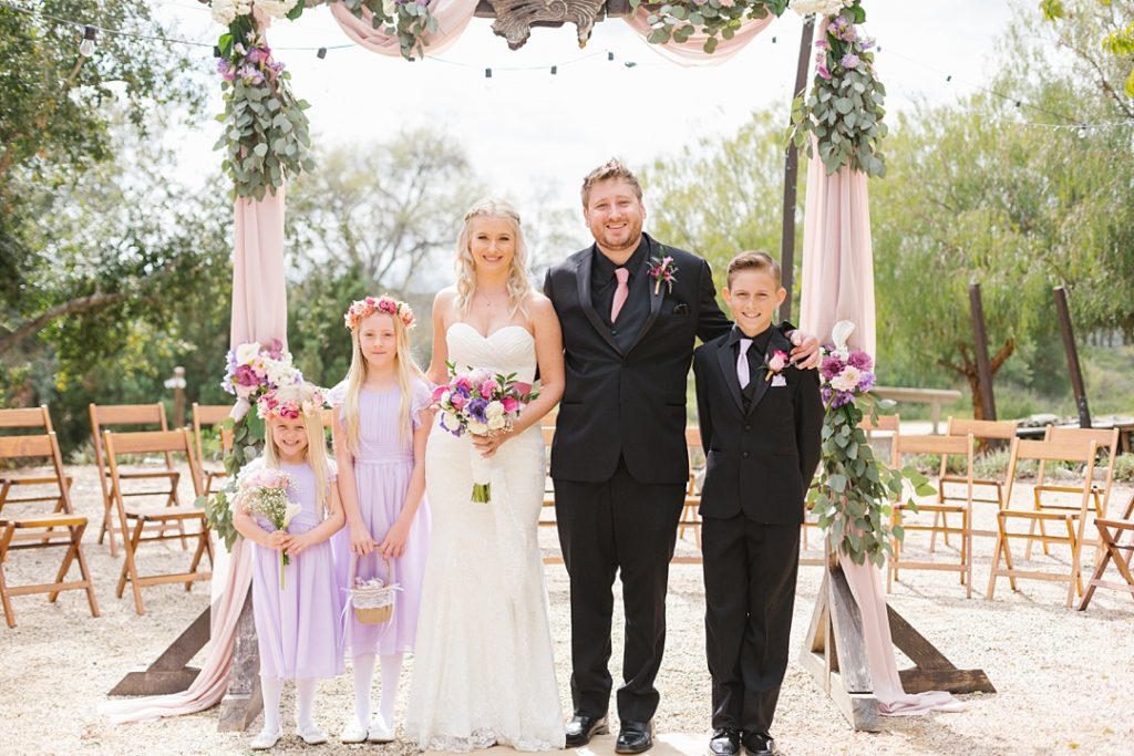 flower girl and ring bearer with bride and groom at spring wedding in SoCal