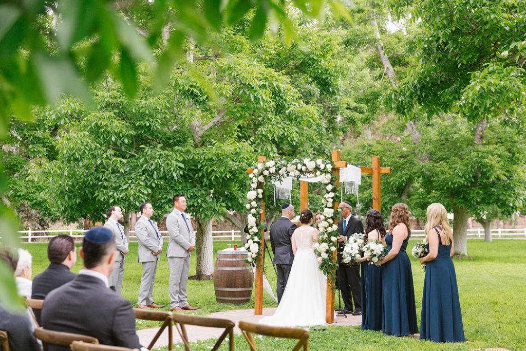 walnut grove wedding ceremony with white and green florals