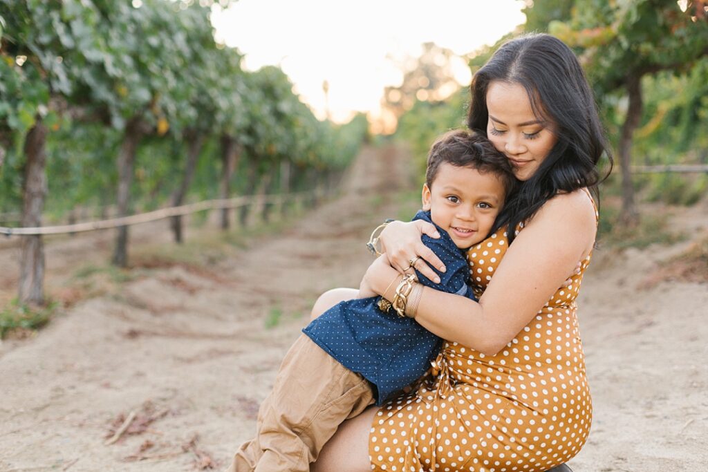 mom and toddler hug at Temecula vineyard portrait session