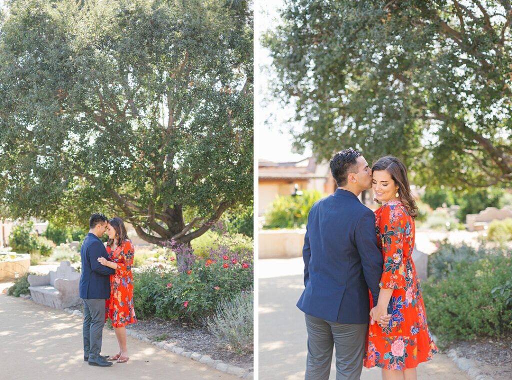 couple walks through garden at Mission San Juan Capistrano during engagement session