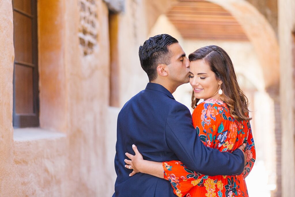 sweet moment during Orange County engagement photos at the mission