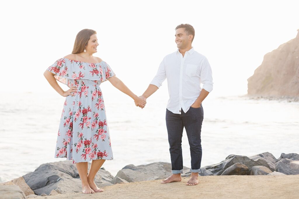 scenic photo of couple holding hands overlooking beach in Orange County