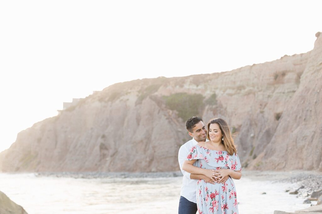 couple stands overlooking bluffs at Dana Point Ocean Institute beach