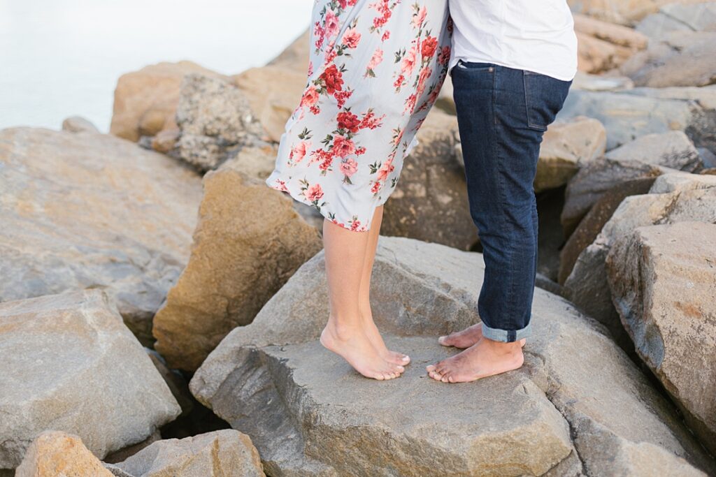 close up of couple standing on rocks at SoCal beach