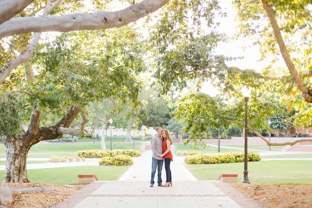 couple stands in walkway at UCLA portrait session