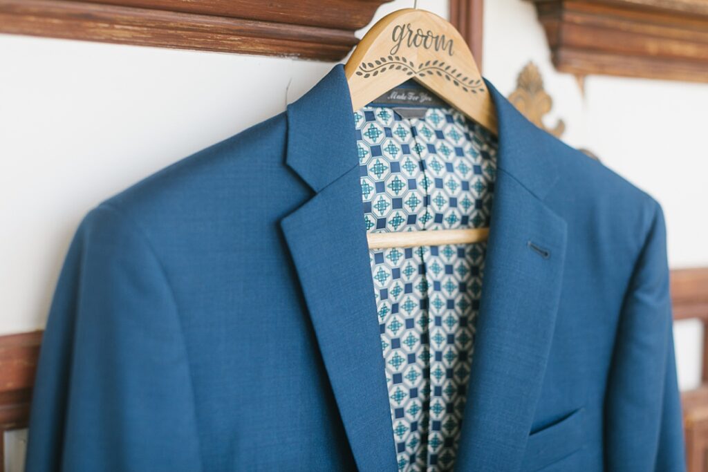 close up of groom's blue jacket with patterned lining