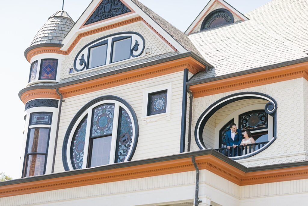bride and groom on balcony at Newhall Mansion in Piru, CA