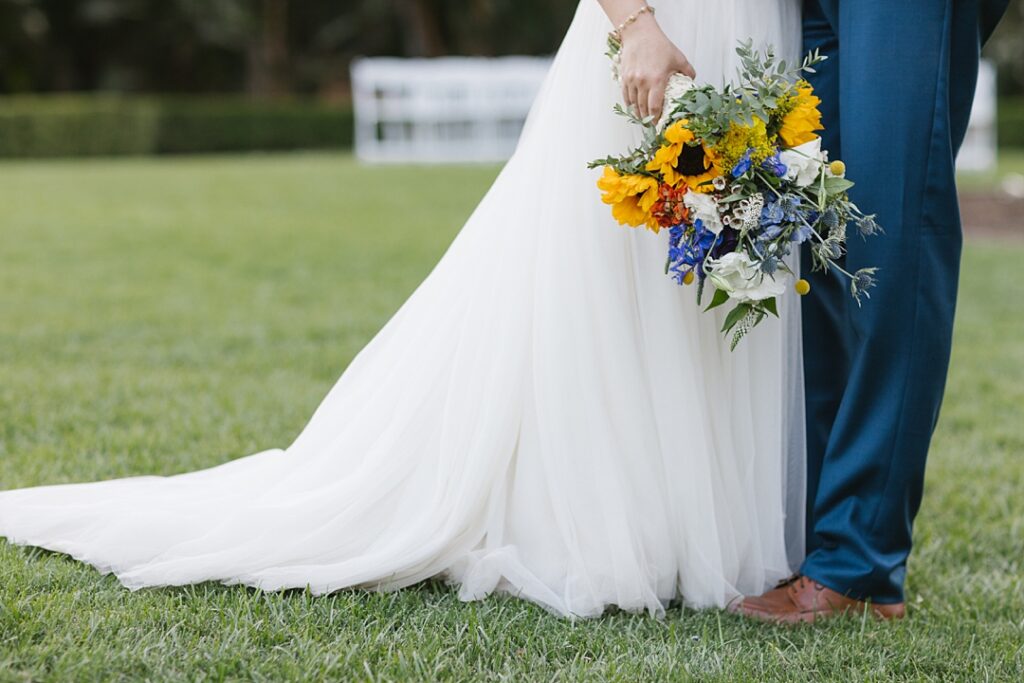 bride holds summer bouquet with sunflowers