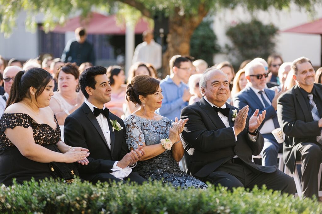 family sits in front row for summer wedding at historic Los Angeles wedding venue