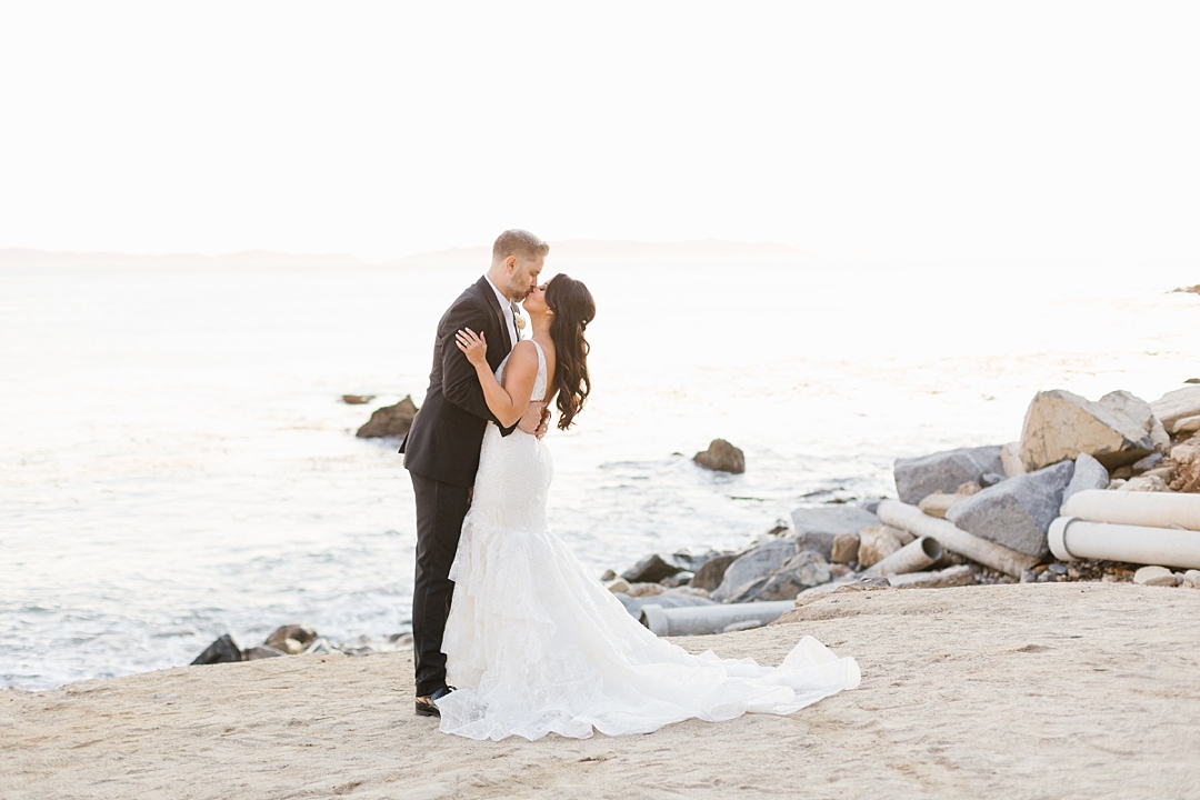 bride and groom kiss at beach at Terranea 