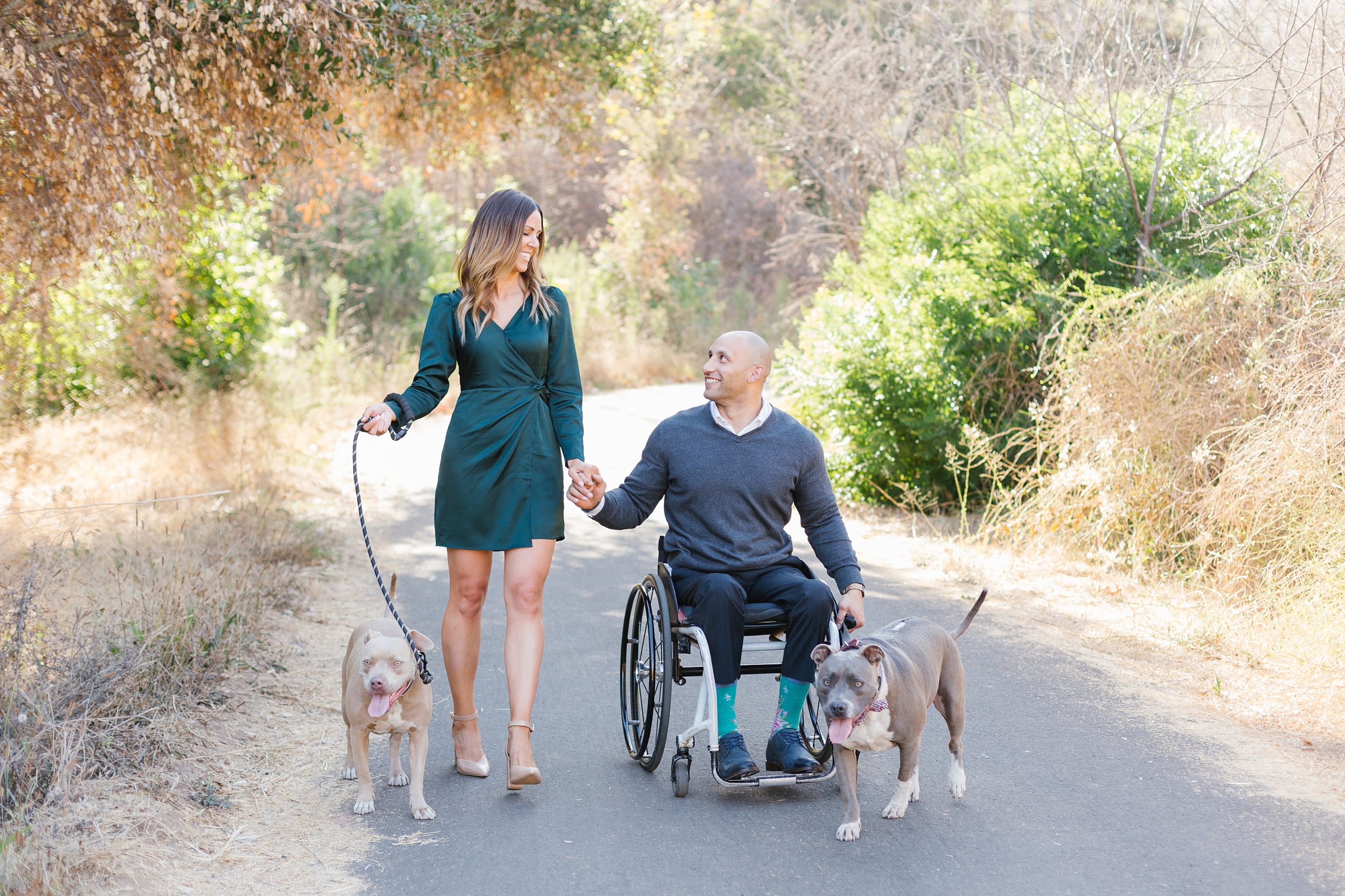 couple strolls with dogs during malibu engagement photos