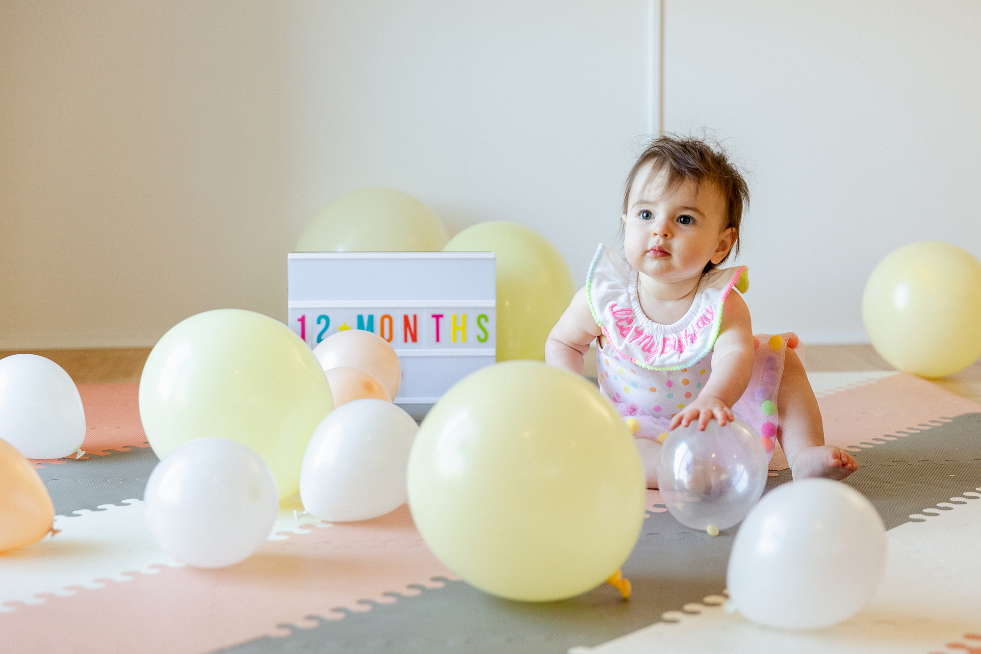 baby with balloons for first birthday photo shoot in los angeles