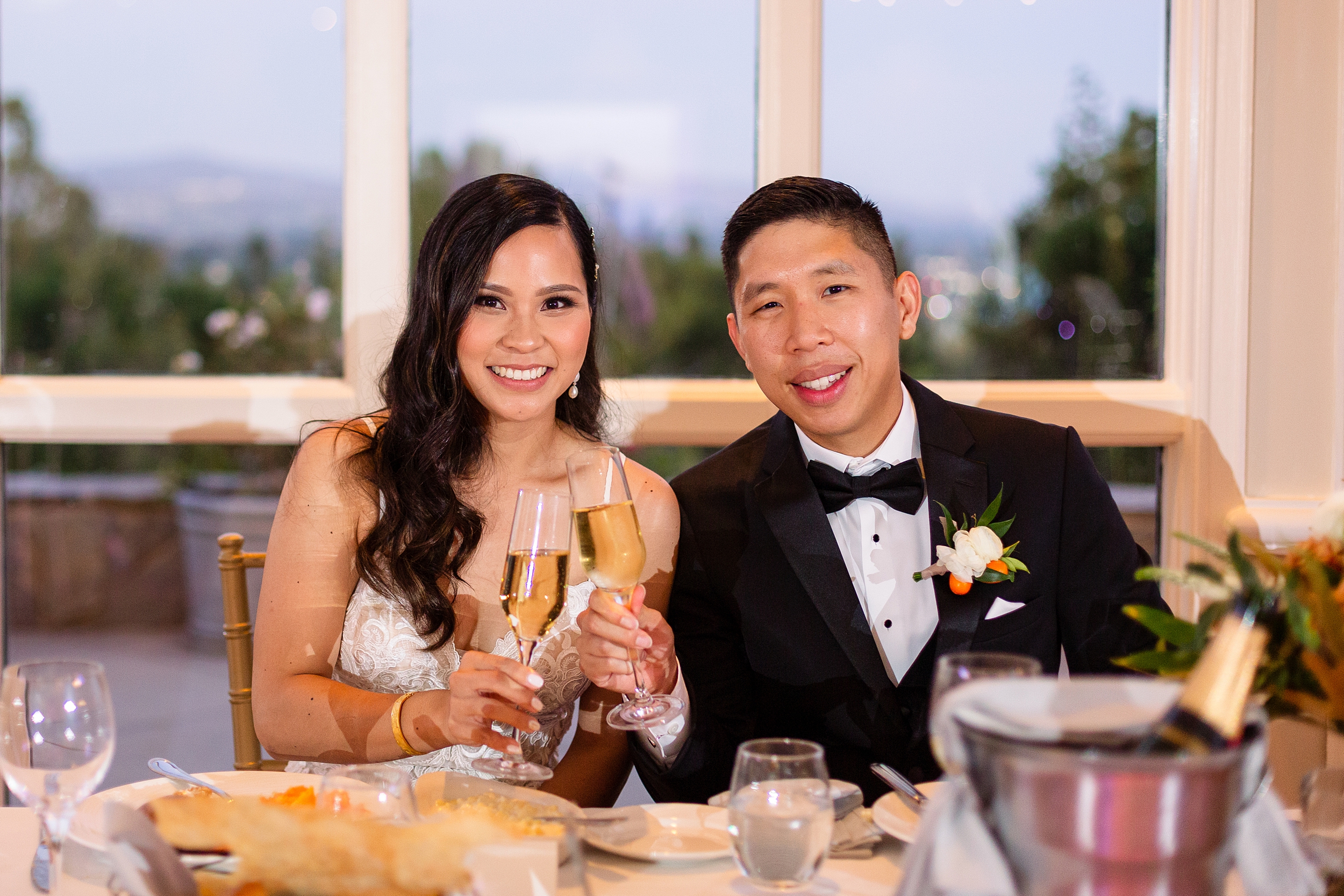 bride and groom toast at orange county wedding reception