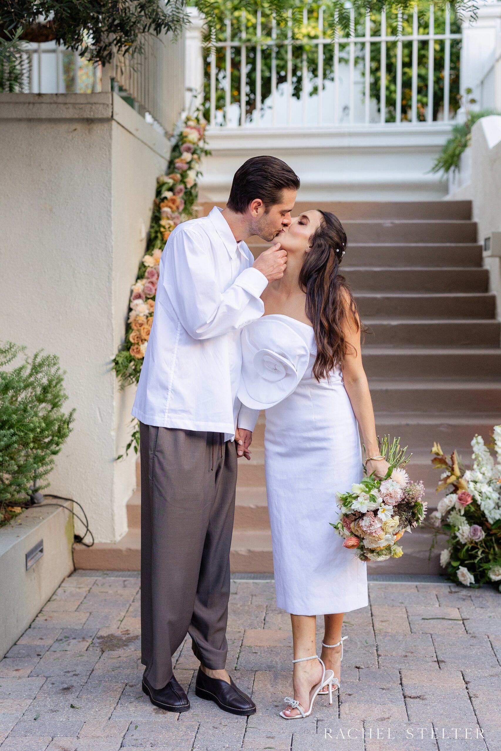 a kiss between bride and groom at Redbird LA