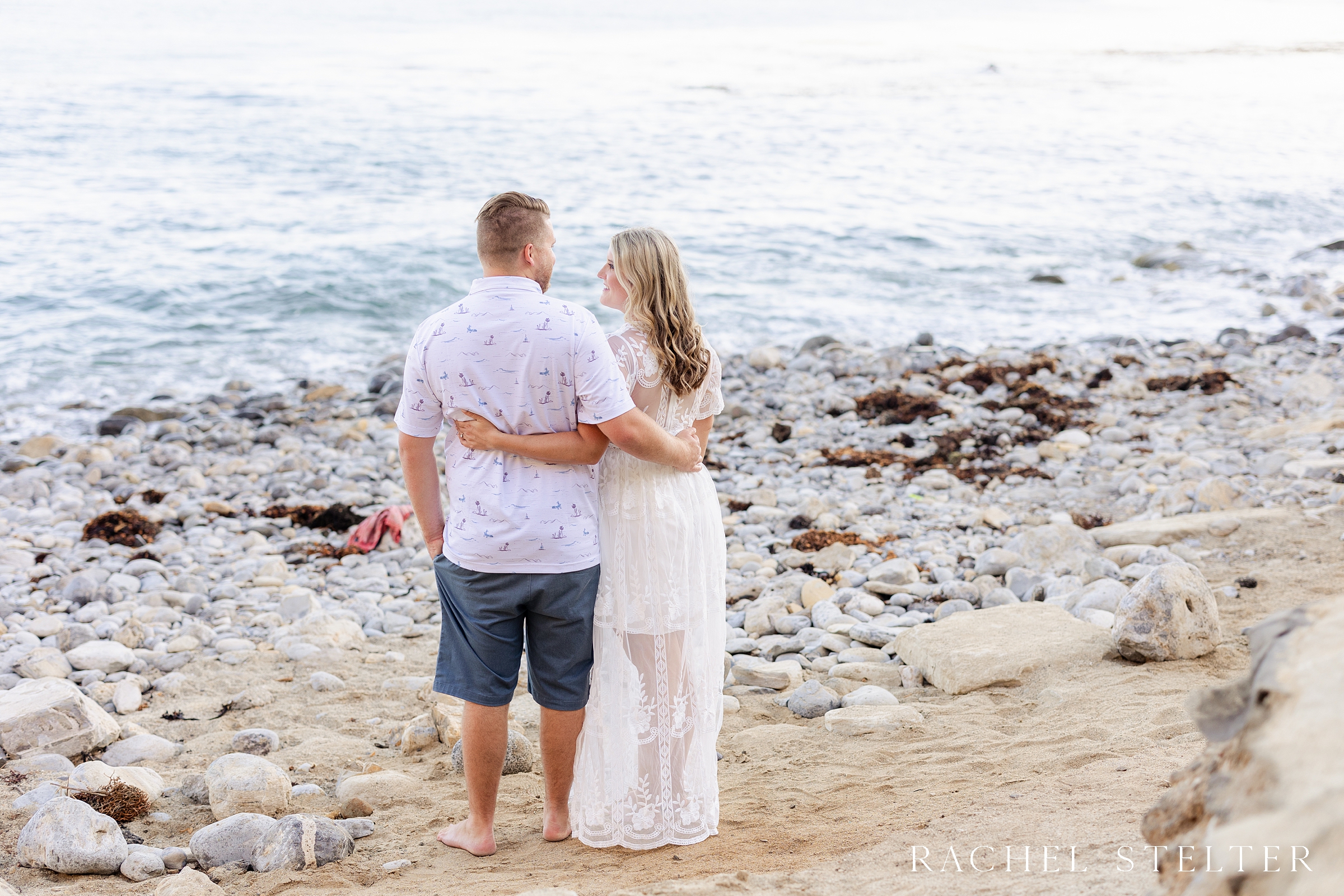 engaged couple embraces at Terranea Beach Cove