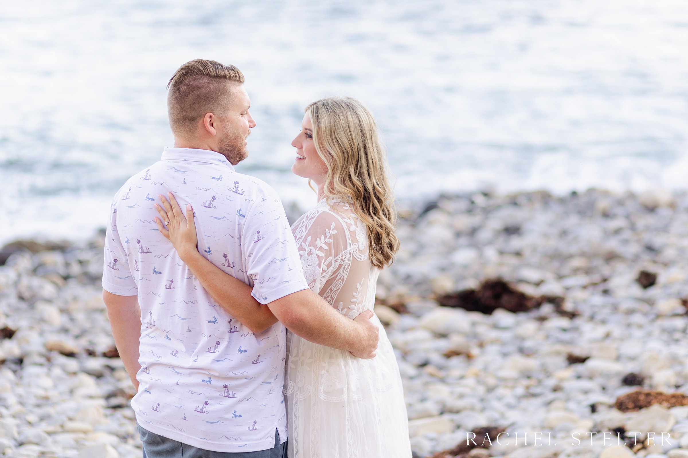 engagement photo session with rocky beach backdrop
