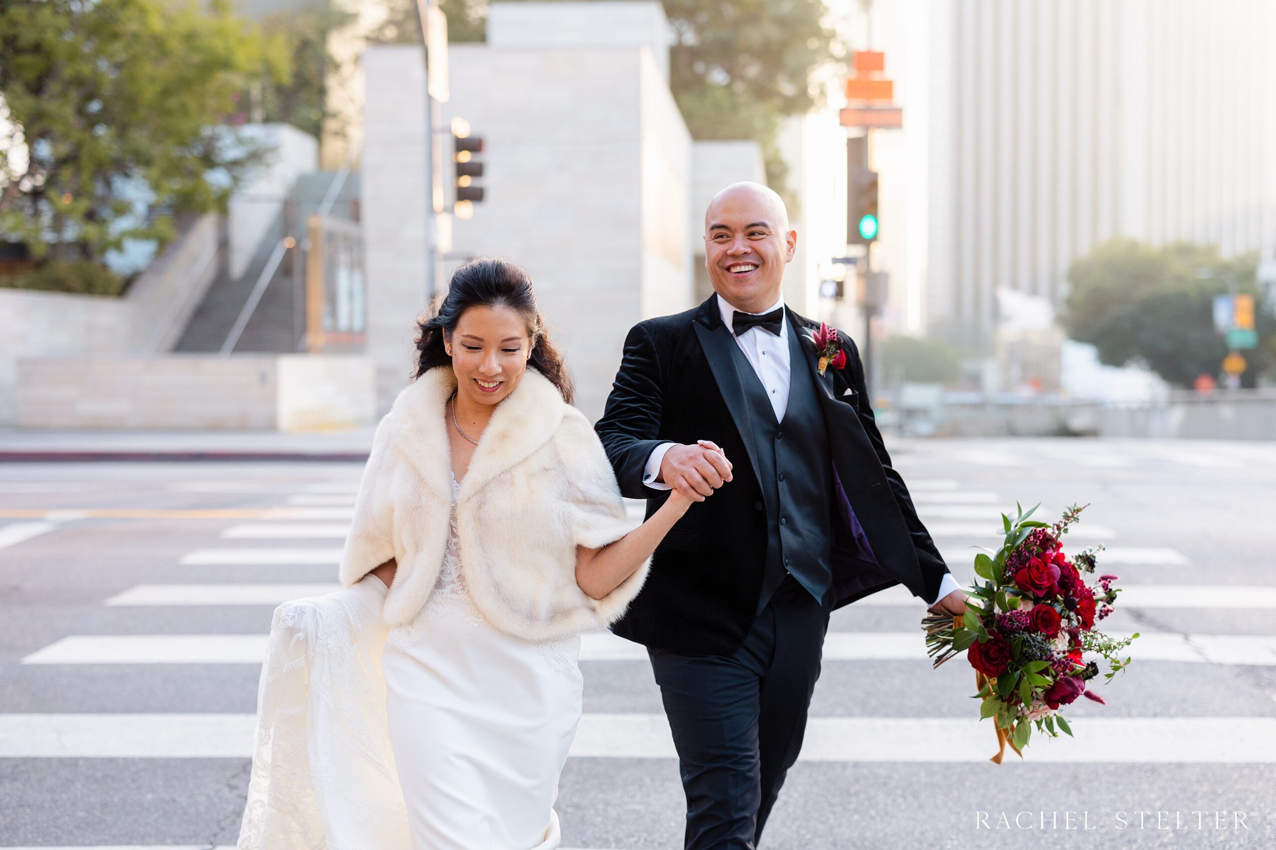 candid of bride and groom crossing the streets of downtown LA