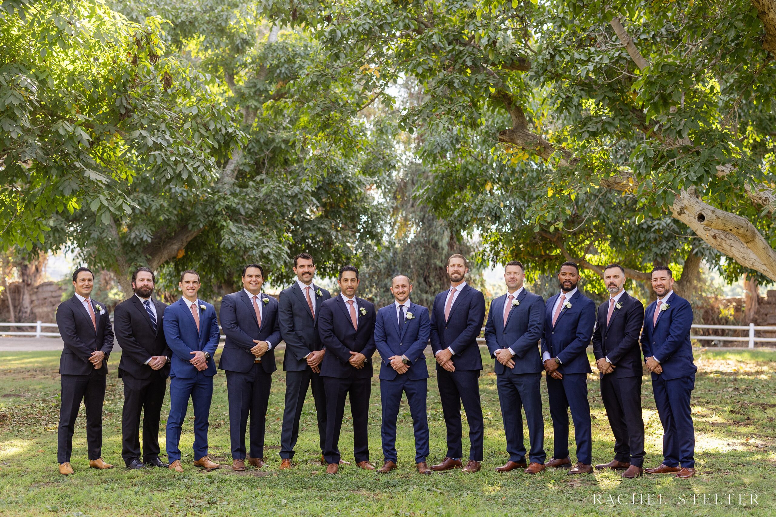 groom and groomsen in dark navy suits at moorpark farm wedding